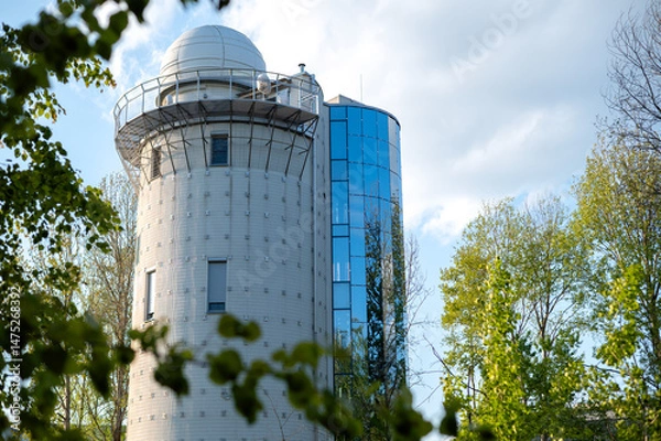 Fototapeta A beautiful astronomical observatory against the sky with clouds.