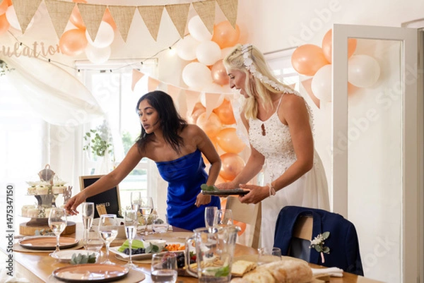 Obraz Bride and friend arranging table settings at festive wedding reception