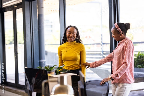 Obraz African American women in office smiling and discussing creative business ideas