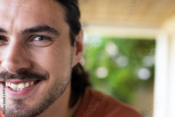 Obraz Smiling man relaxing outdoors, enjoying leisure time and showing happiness