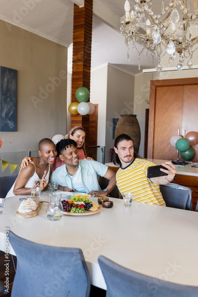 Obraz Friends taking selfie at home, celebrating with food and drinks, smiling joyfully