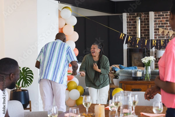 Obraz Family celebrating retirement at home, laughing and enjoying festive decorations
