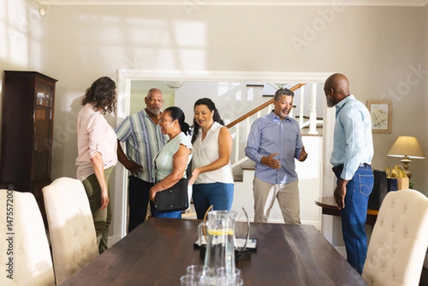 Obraz Family gathering at home, diverse group chatting and enjoying each other's company