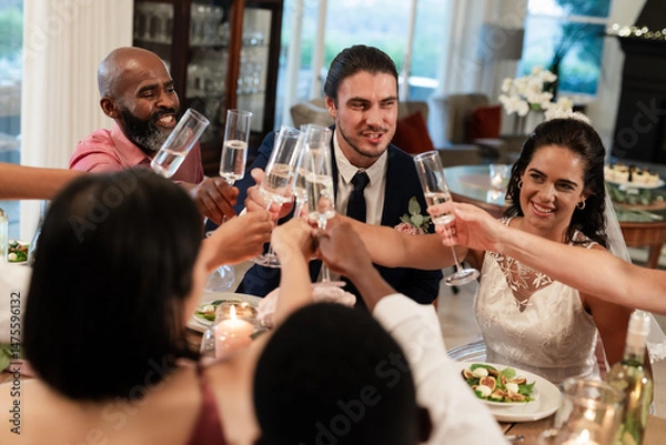Obraz Toasting with champagne, diverse friends celebrating wedding around elegant dinner table