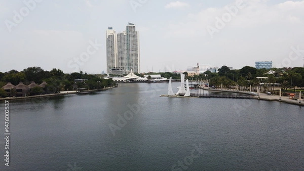 Obraz Modern skyscrapers reflecting in the lake's water under the sky