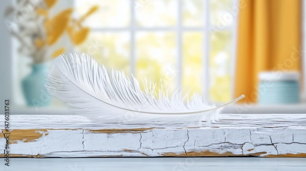 Obraz A delicate white feather resting on a rustic wooden surface, illuminated by soft natural light, creating a serene and tranquil atmosphere