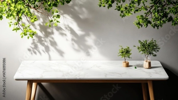 Obraz Minimalist interior showcasing marble table with plant decor and sunlit wall background for product presentation.