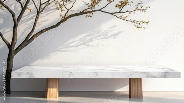 Obraz A marble table stands next to a bare tree, its branches casting shadows on the white wall in a modern scene.