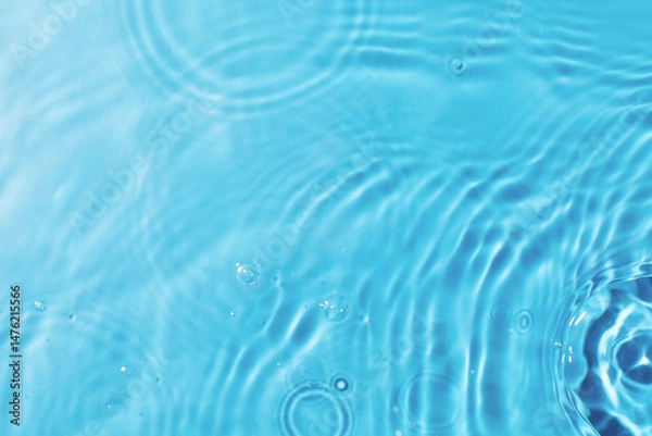 Obraz Rippling water texture background for design. Pouring clear water on light blue background upper 
