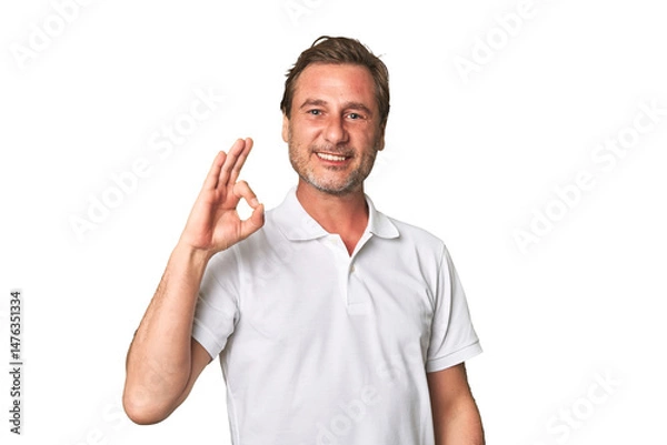 Fototapeta A middle-aged man isolated cheerful and confident showing ok gesture.