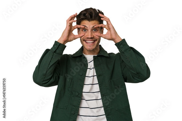Fototapeta Young handsome caucasian man isolated on white background keeping eyes opened to find a success opportunity.