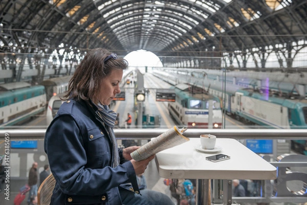 Fototapeta Woman Making a Coffee Break in Railway Station in Milan, Lombardy, Italy.