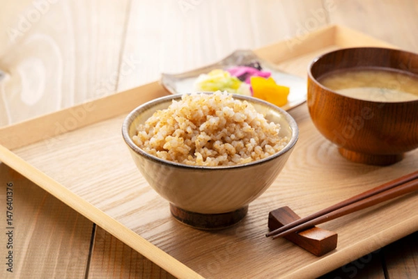 Fototapeta Freshly Cooked Brown Rice on a Table with Miso Soup and Pickles, Japanese Breakfast Concept
