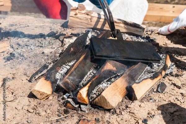 Fototapeta Waffle baking in an open fire