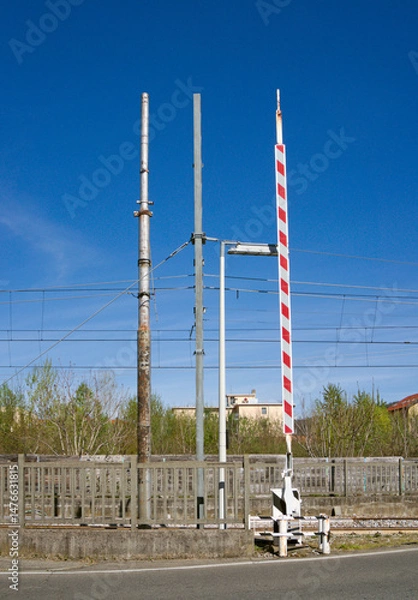 Fototapeta power poles and rail crossing barrier raised up