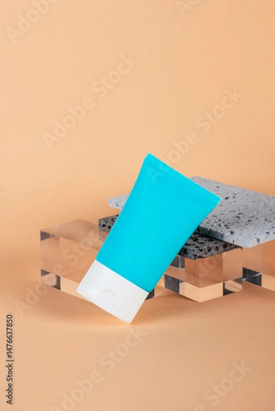 Fototapeta Cosmetic product in tube, bottle, lotion or serum with stylish props on cream background. 