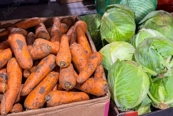 Obraz Fresh organic vegetables carrots and green cabbages displayed in a rustic wooden crate at a vibrant local farmers market showcasing healthy produce options