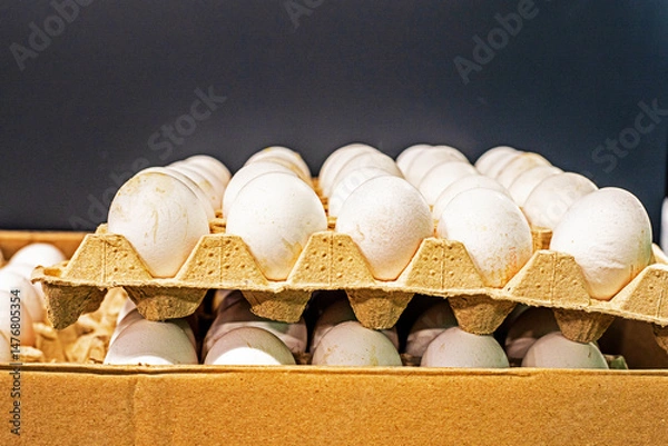 Fototapeta chicken white eggs in a cardboard container in the supermarket. Economic crisis