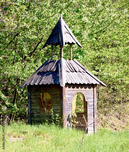 Fototapeta  small wooden structure resembling a chapel with two pitched roofs