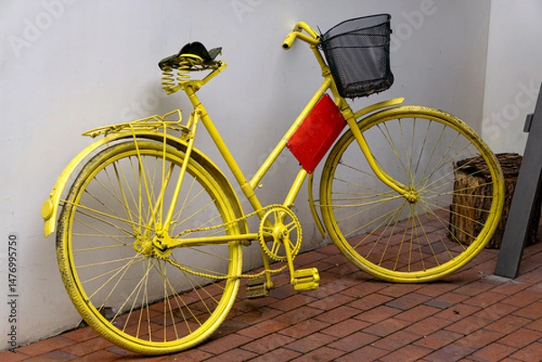 Obraz Beautiful side view close up of an old creative bicycle painted yellow.