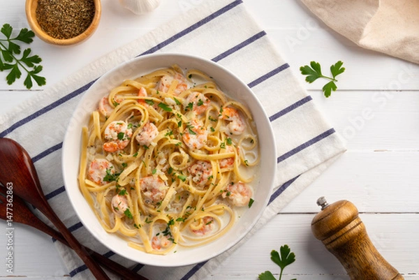 Fototapeta Fettuccine pasta with shrimp in white cream sauce.Creamy Shrimps Spaghetti carbonara sauce in white plate.Top view.