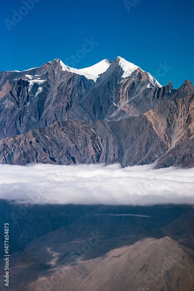 Obraz High rocky mountains with the glaciers above the clouds. Himalaya, Nepal.
