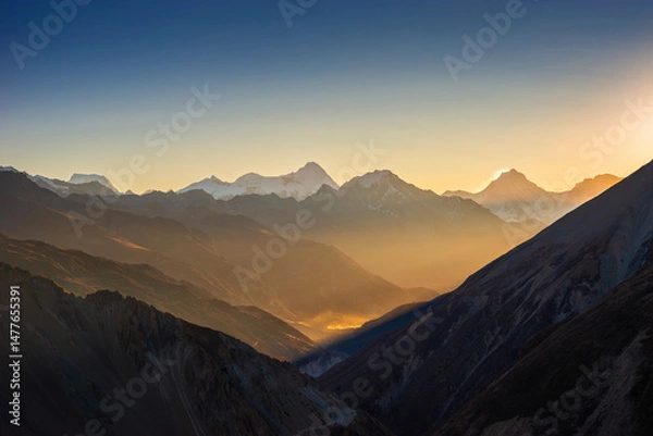Obraz Himalaya mountains at sunrise. Himlung and Manaslu summits behind Pisang peak illuminated by first rays of the sun. View from the trekking route to Tilicho lake.
