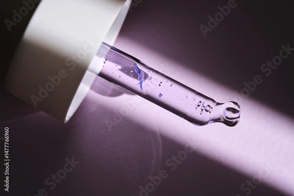 Fototapeta Pipette with serum on purple background with sunlight.