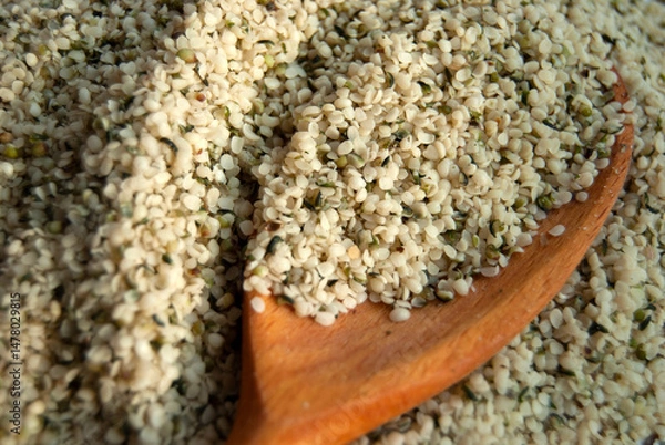 Fototapeta Hemp seeds close-up. Organic hemp seeds with a wooden spoon.