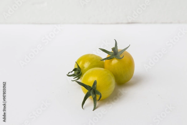Obraz Yellow Cherry Tomatoes on White Background