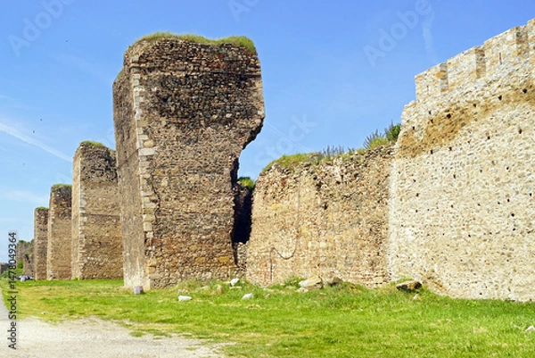 Obraz View of a medieval fortification in urgent need of restoration: defensive walls with powerful towers, one of which has a crack and is strongly tilted to the side. Visit to the fortress in Smederevo 