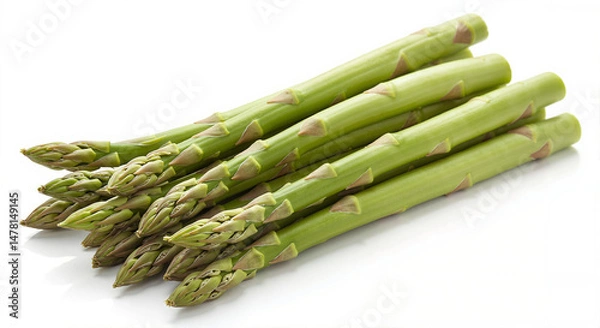Obraz Fresh green asparagus spears stacked on a white background  