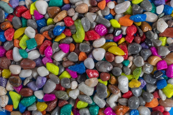 Fototapeta Collection of colorful shiny stones and pebbles in a variety of vibrant colors.