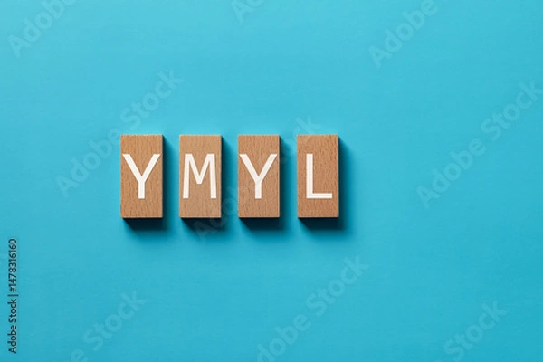 Obraz There is wood block with the word YMYL. It is an abbreviation for Your Money or Your Life as eye-catching image.