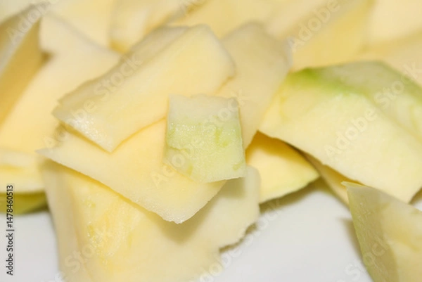 Fototapeta Peeled and Diced Mango Ready to Eat. Mango with Blurred Background. Mango Pieces, Healthy Snack. mango with selective focus.