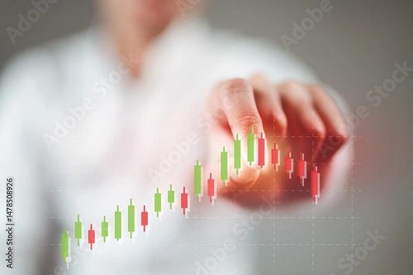 Fototapeta A businessman in a white shirt is tapping on an uptrend stock chart, causing the stock to fall.