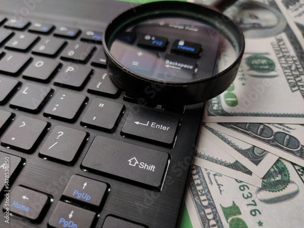 Fototapeta Closeup magnifying glass,banknote and keyboard business online concept