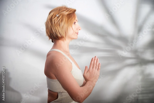 Fototapeta Practicing yoga and mindfulness at home for a balanced and healthy lifestyle