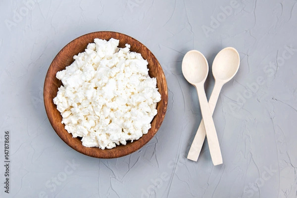 Obraz Homemade cottage cheese, curd in a wooden bowl on a grey rustic background. Healthy food. Top view, free space.