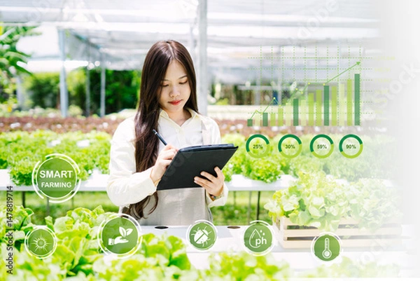 Obraz Smart Farming Technology and Young Woman in Greenhouse Setting