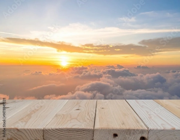Fototapeta A rustic wooden table sits invitingly, showcasing a breathtaking view of fluffy white clouds drifting across a bright blue sky, creating a serene atmosphere.