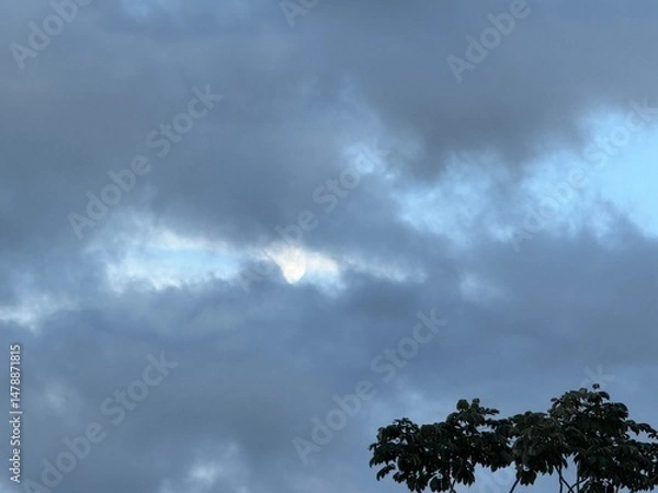 Fototapeta Moon creeping out of storm clouds 