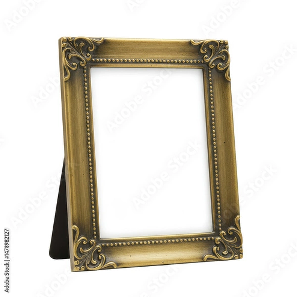 Fototapeta Ornate, empty gold frame with delicate scroll details, standing on a black easel, against black backdrop