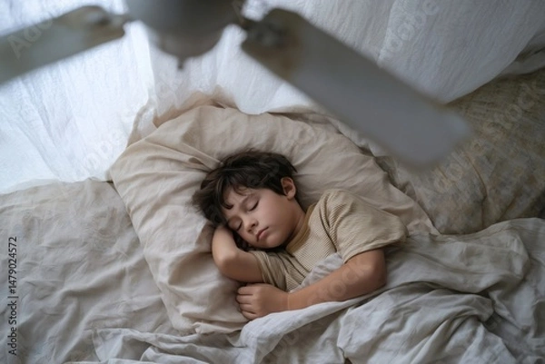 Fototapeta Sleeping soundly in soft light with a gentle fan: A serene childhood moment of peaceful rest and comfort.