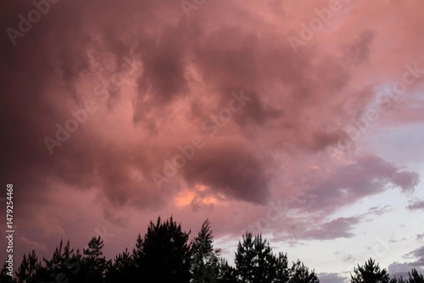 Obraz Fiery red storm clouds with dramatic lighting. Red storm clouds background. Dramatic red sky.