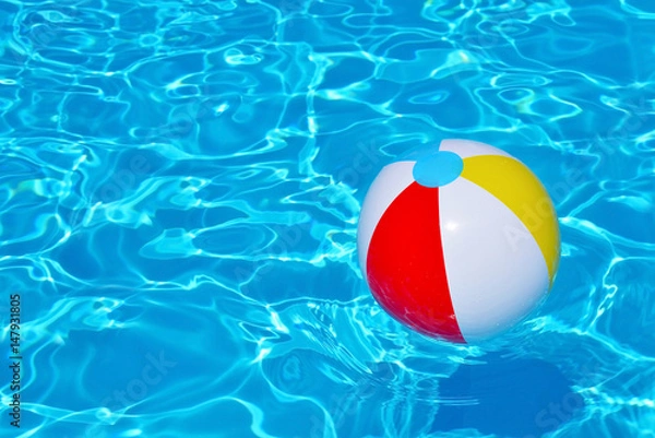 Fototapeta Colorful inflatable ball floating in swimming pool
