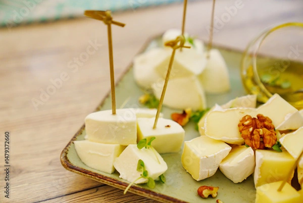 Obraz Cheese platter with sauces and honey on a plate.