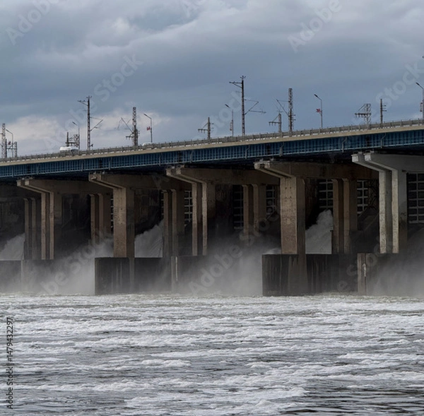 Fototapeta Water Discharge at Hydroelectric Power Station During Cloudy Conditions With Hydro Turbines in Operation Producing Energy