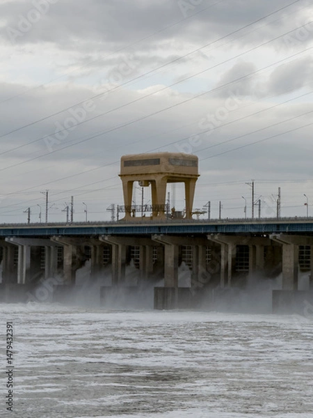 Obraz Water Discharge at Hydroelectric Power Station During Cloudy Conditions With Hydro Turbines in Operation Producing Energy