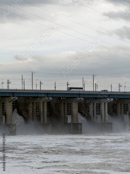 Obraz Water Discharge at Hydroelectric Power Station During Cloudy Conditions With Hydro Turbines in Operation Producing Energy
